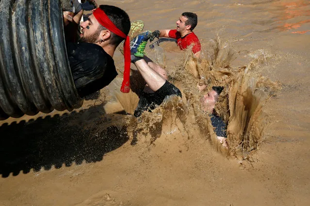 Participants compete in the Mud Day Race extreme run competition at El Goloso military base, outside Madrid, Spain, June 11, 2016. (Photo by Juan Medina/Reuters)