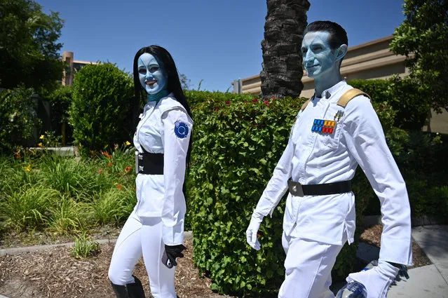 Star Wars fans dressed as Grand Admiral Thrawn (R) attend the first day of the Star Wars Live Celebration, at the Anaheim Convention Center, in Anaheim, California on May 26, 2022. Many of the fans are cosplay enthusiasts attending the event in costume of their favorite character. The event runs through May 29. (Photo by Robyn Beck/AFP Photo)