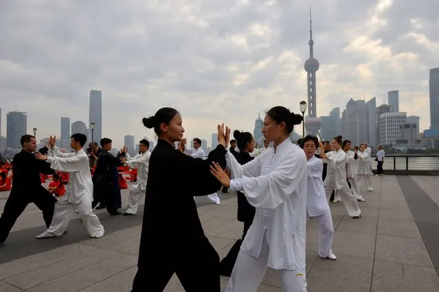 Participants practise Taichi during a local festival in Shanghai, China, June 18, 2016. (Photo by Guo Changyao/Reuters)