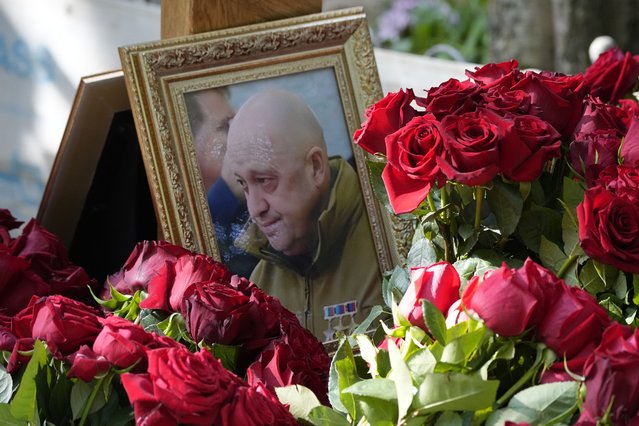 A portrait of Wagner Group's chief Yevgeny Prigozhin, who died last week in a plane crash two months after launching his brief rebellion, lies on flowers on the grave at the Porokhovskoye cemetery in St. Petersburg, Russia, on Wednesday, August 30, 2023. (Photo by Dmitri Lovetsky/AP Photo)