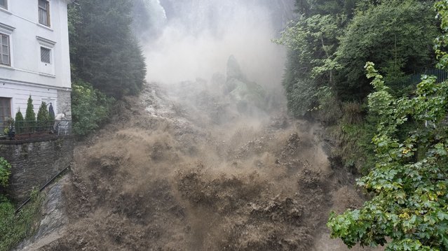 Muddy water rolls down on the rocks at the waterfall in the centre of the village Bad Gastein, also known as the “Monaco of the Alps”, south of Salzburg, Austria, on August 28, 2023. Authorities in Tyrol and Salzburg provinces in western Austria put people on alert on Monday amid flooding and landslide risks due to heavy rains. (Photo by FMT-Pictures/APA via AFP Photo)