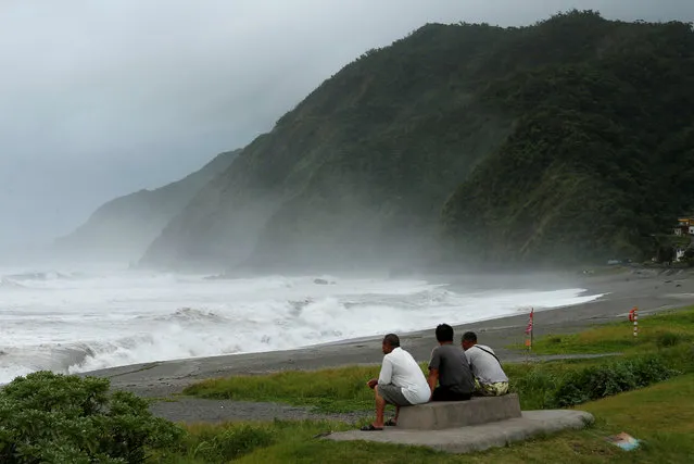 Men watch waves crash at the coast as Typhoon Nepartak approaches in Yilan, Taiwan July 7, 2016. (Photo by Tyrone Siu/Reuters)