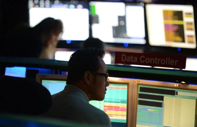 Mars Science Laboratory (MSL) mission members work in the data processing room beside Mission Control at the Jet Propulsion Laboratory (JPL) in Pasadena, California, on August 2, 2012 ahead of the landing of the Mars rover Curiosity. NASA said Thursday all was well ahead of its nail-biting mission to Mars, with its most advanced robotic rover poised to hunt for clues about past life and water on Earth's nearest planetary neighbor. (Photo by Robyn Beck/AFP)