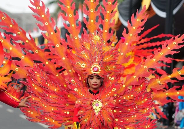 A model wears a Phoenix costume in the kids carnival during The 13th Jember Fashion Carnival 2014 on August 21, 2014 in Jember, Indonesia. (Photo by Robertus Pudyanto/Getty Images)