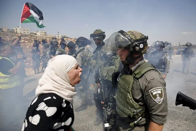 A Palestinian woman argues with an Israeli border policeman during a protest against Jewish settlements in the West Bank village of Nabi Saleh, near Ramallah September 4, 2015. (Photo by Mohamad Torokman/Reuters)