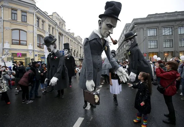 Giant figures depicting Russian authors Anton Chekhov, Alexander Pushkin, Daniil Kharms and Fyodor Dostoyevsky are seen during a carnival to celebrate City Day in central Moscow, Russia, September 5, 2015. (Photo by Sergei Karpukhin/Reuters)