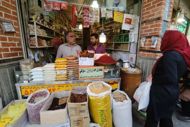 Iranians shop at Tehran's ancient Grand Bazaar on July 11, 2016. A year ago, a landmark nuclear deal with world powers led jubilant Iranians to dream of an end to isolation and economic hardship, but critics say US obstacles have soured those hopes. Despite many sanctions being lifted, the international banking system is still too nervous to work with Iran. (Photo by Atta Kenare/AFP Photo)