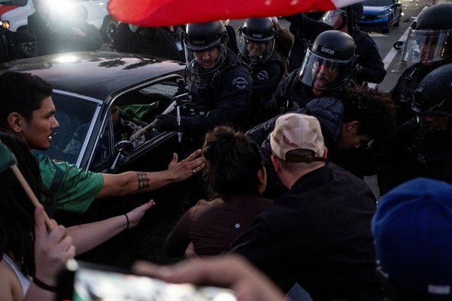 Police officers clash with protestors rallying against the arrests and deportations of migrants by U.S. government agencies in Los Angeles, California, U.S. February 3, 2025. (Photo by Joel Angel Juarez/Reuters)