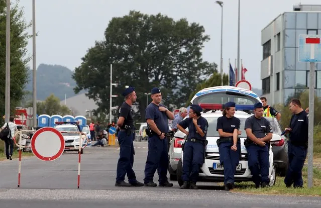 Hungarian police rest at the border check point in the village of Szentgotthard, Hungary September 14, 2015. (Photo by Srdjan Zivulovic/Reuters)