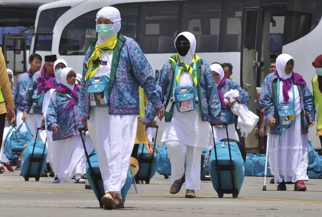 Indonesian Haj pilgrims walk towards their flight at the airport in Solo, Central Java province, Indonesia September 17, 2015, in this photo taken by Antara Foto. Indonesia gets the largest annual Haj quota from Saudi Arabia – 168,000 places – and stiff competition guarantees all will be filled. (Photo by Aloysius Jarot Nugroho/ReutersAntara Foto)