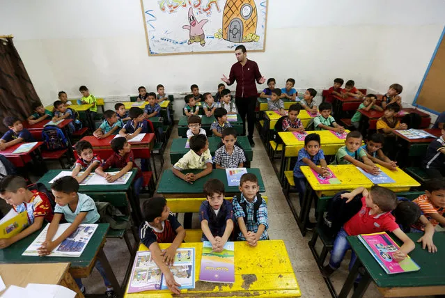 Refugee schoolchildren attend a lesson in a classroom on the first day of the new school year at one of the UNRWA schools at a Palestinian refugee camp al Wehdat, in Amman, Jordan, September 1, 2016. (Photo by Muhammad Hamed/Reuters)