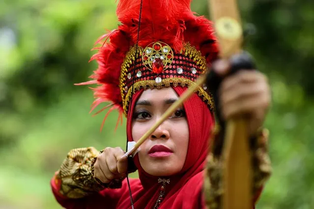 An Indonesian woman traditional archer Dhanisa Restya Agung poses for a photograph during an International traditional archery festival at Seri Menanti in Negeri Sembilan, about 90kms of Kuala Lumpur on January 28, 2018. (Photo by Manan Vatsyayana/AFP Photo)