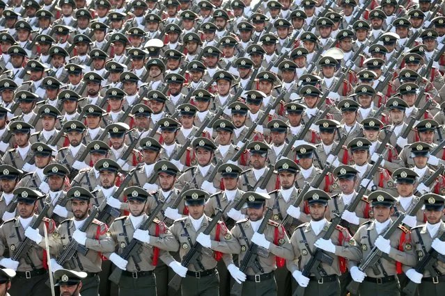 Iranian armed forces members march in a military parade marking the 36th anniversary of Iraq's 1980 invasion of Iran, in front of the shrine of late revolutionary founder Ayatollah Khomeini, just outside Tehran, Iran, Wednesday, September 21, 2016. Iran's chief of staff of the armed forces said Wednesday a $38 billion aid deal between the United States and Israel makes Iran more determined to strengthen its military. (Photo by Ebrahim Noroozi/AP Photo)
