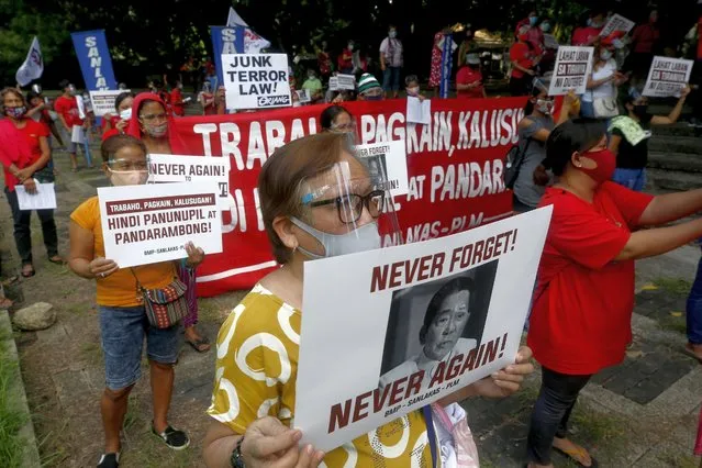 A protester (front) holds a sign with a composite image of the late president Ferdinand Marcos and current president Rodrigo Duterte during a rally against Martial Law at the Bantayog ng mga Bayani (Monument of Heroes) in Quezon City, Metro Manila, Philippines, 21 September 2020. The protest marked 48 years since Marcos declared Martial Law on 21 September 1972. Marcos was eventually ousted from power by a People Power Revolution in February 1986. (Photo by Rolex Dela Pena/EPA/EFE/Rex Features/Shutterstock)