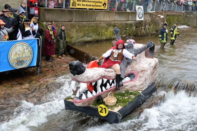 Carnival revellers ride down the Schiltach stream atop their float during the “Bach na fahre” (race down the stream) raft contest on Rose Monday in the south-western Black Forest town of Schramberg, Germany, February 12, 2018. (Photo by Steffen Schmidt/Reuters)