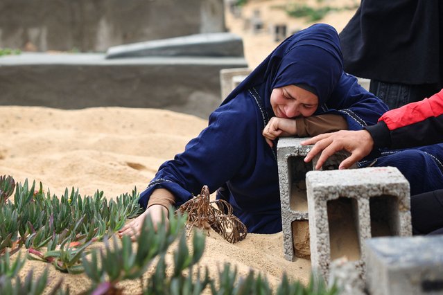 A woman cries over the grave of a loved one at the start of the Eid al-Fitr festival, marking the end of the Muslim holy month of Ramadan, at a cemetary in Rafah in the southern Gaza Strip, on April 10, 2024, amid the ongoing conflict between Israel and the militant group Hamas. (Photo by AFP Photo/Stringer)