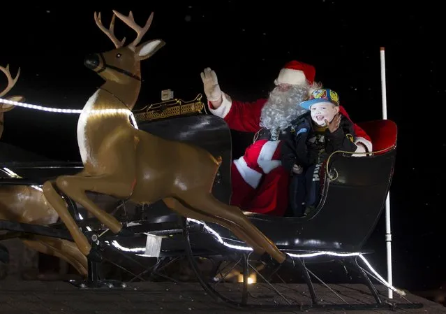 Evan Leversage, who is terminally ill with brain cancer, rides off in the Santa Claus float during a Christmas parade in St. George, Ontario, Canada October 24, 2015. (Photo by Mark Blinch/Reuters)