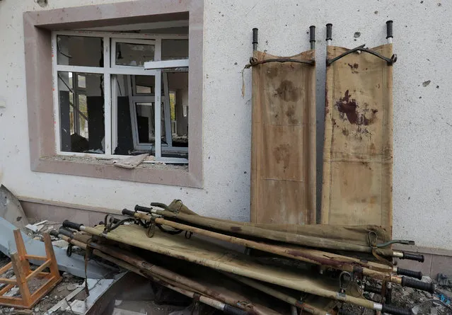 Stretchers are seen outside a hospital, which, according to the Ministry of Foreign Affairs of the Nagorno-Karabakh region, was damaged during recent shelling by Azeri armed forces, in the fighting over the breakaway region of Nagorno-Karabakh, in Martakert on October 15, 2020. (Photo by Reuters/Stringer)