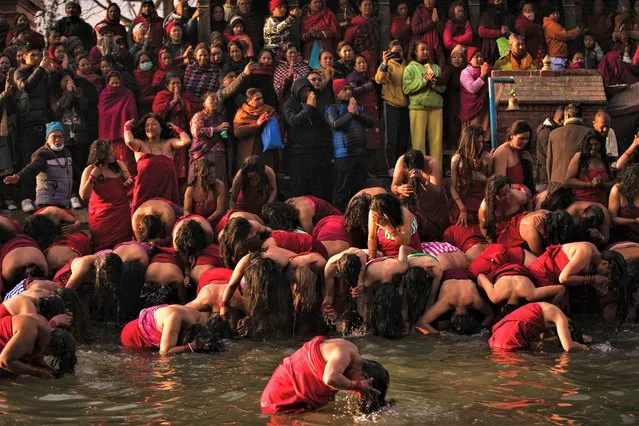 Nepalese Hindu devotees bathe on the month-long Swasthani festival in the Triveni River, Panauti village on January 25, 2023. The month-long festival, dedicated to God Madhavnarayan and Goddess Swasthani, involves the recitation of folk tales about miraculous feats performed by them in many Hindu households. (Photo by Prabin Ranabhat/SOPA Images/Rex Features/Shutterstock)