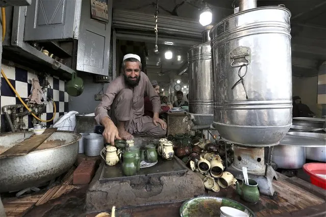 A vendor prepares tea for customers at a traditional restaurant in Peshawar, Pakistan, Wednesday, February 1, 2023. Peshawar, a key mountain valley connecting South and Central Asia, was once known as “the city of flowers”, surrounded by orchards of pear, quince, and pomegranate trees. But for the past four decades, it has borne the brunt of rising militancy in the region, fueled by the conflicts in neighboring Afghanistan. (Phoot by Muhammad Sajjad/AP Photo)