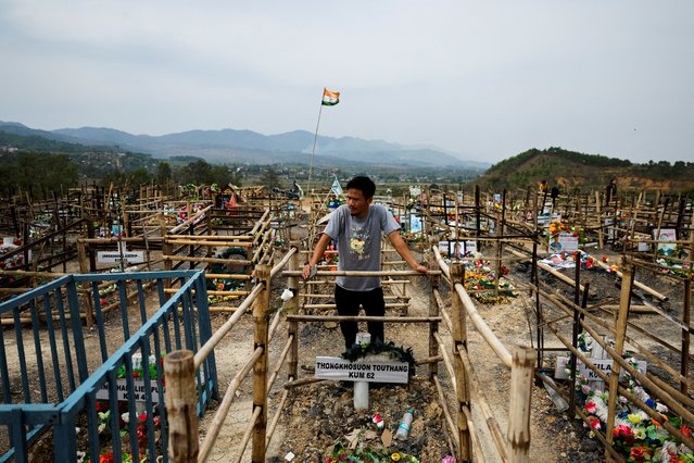 Lalboi Touthang, 30, a Kuki, visits the grave of his late uncle Thongkhosuon Touthang after he died in ethnic violence in Churachandpur, Manipur, India, on April 10, 2024. The state of 3.6 million people has been ravaged by fighting between the majority Meitei and tribal Kuki-Zo people for about a year, and continues to be divided into two enclaves: a valley controlled by the Meiteis and the Kuki-dominated hills, separated by a stretch of “no man's land” monitored by federal paramilitary forces. (Photo by Francis Mascarenhas/Reuters)