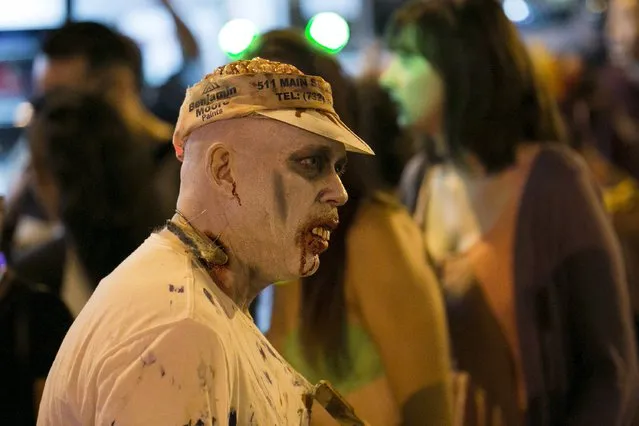 A man dressed as a zombie participates in the West Hollywood Halloween Costume Carnaval, which attracts nearly 500,000 people annually, in West Hollywood, California October 31, 2015. (Photo by Jonathan Alcorn/Reuters)
