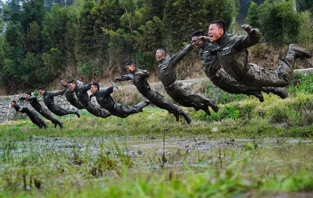 Chinese commandos combat in the mud during a seven-day extreme military exercises at Xiuwen County on March 22, 2018 in Guiyang, Guizhou Province of China. Commandos will be evaluated after 20 testing items to test their intelligence, tactics, psychological ability and ability to survive in the wild. (Photo by He Junyi/China News Service/VCG via Getty Images)