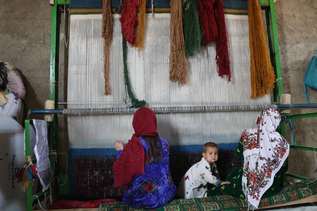 Afghan women work at a carpet loom in Herat, Afghanistan, 28 September 2020. Nearly 19 years after the fall of the Taliban regime and the United States invasion, the Afghan government and insurgents on 12 September, began peace negotiations in Doha. Unlike the Taliban team, the 21-member negotiating group sent by Kabul includes four women, who – among other things – will look to safeguard the progress on women's rights since the fall of the Taliban regime that had prevented girls from going to schools and confined women to their homes. (Photo by Jalil Rezayee/EPA/EFE)