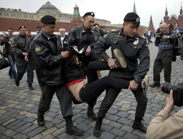 Police officers detain a demonstrator in Moscow's Red Square, during an action in support of opposition activists arrested in a massive anti-president Putin rally last May, on April 27, 2013. (Photo by Ivan Sekretarev/Associated Press)