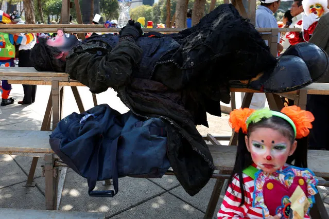 A clown rests during the XXI Convention of Clowns, at the Jimenez Rueda Theatre, in Mexico City, Mexico, October 19, 2016. (Photo by Carlos Jasso/Reuters)
