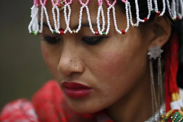 A Tharu girl dressed in traditional attire participate in a parade marking an Elephant Festival event at Sauraha in Chitwan, about 170 km (106 miles) south of Kathmandu December 26, 2014. (Photo by Navesh Chitrakar/Reuters)