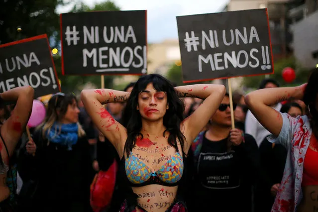 A demonstrator depicting lacerations is seen during a peaceful march against the gender violence in Santiago, Chile, October 19, 2016. The posters reads “Not one less!”. (Photo by Ivan Alvarado/Reuters)