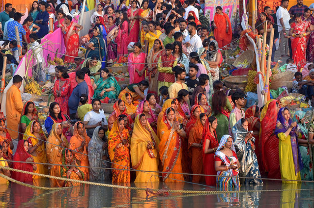 Devotees offer prayer on the bank of the river Brahmaputra as part of Chhath Puja in Guwahati, India on October 27, 2025. (Photo by Dasarath Deka/ZUMA Press Wire/Rex Features/Shutterstock)