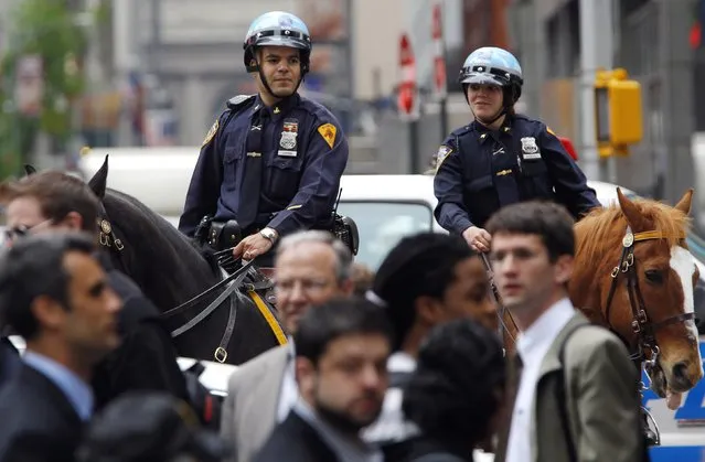 New York City mounted police look over pedestrians in New York's Times Square as police investigated a suspicious package in this file photo taken May 2, 2011.  Highly visible police officers on horseback who patrol crowded sites like New York's Times Square are an essential part of the city's high alert in the wake of the deadly Paris attack, police officials said on Wednesday. (Photo by Mike Segar/Reuters)