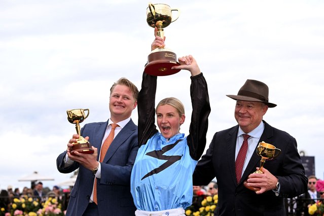 Half Yours Australian jockey Jamie Melham (C) holds the trophy with trainers Calvin McEvoy (L) and Tony McEvoy (R) after her victory in the Melbourne Cup horse race at the Flemington Racecourse in Melbourne on November 4, 2025. Melham became only the second woman jockey to win the Aus$10 million (US$6.5 million) Melbourne Cup on November 4, steering Half Yours to victory in Australia's “race that stops a nation”. (Photo by William West/AFP Photo)