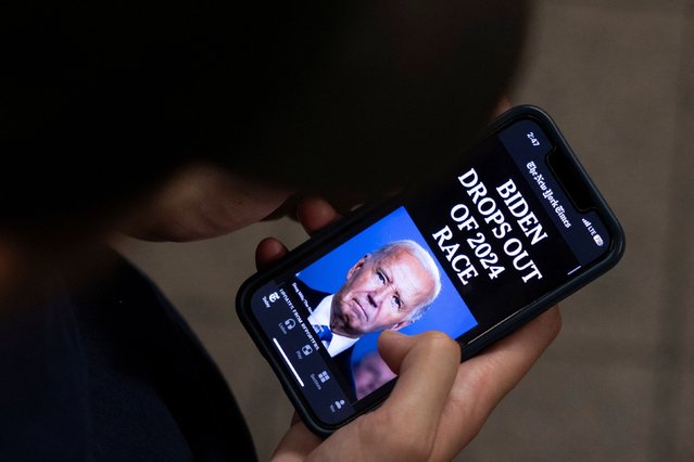 A person looks at a New York Times news article on U.S. President Joe Biden's announcement that he is dropping his reelection bid, in New York City, U.S., July 21, 2024. (Photo by Caitlin Ochs/Reuters)