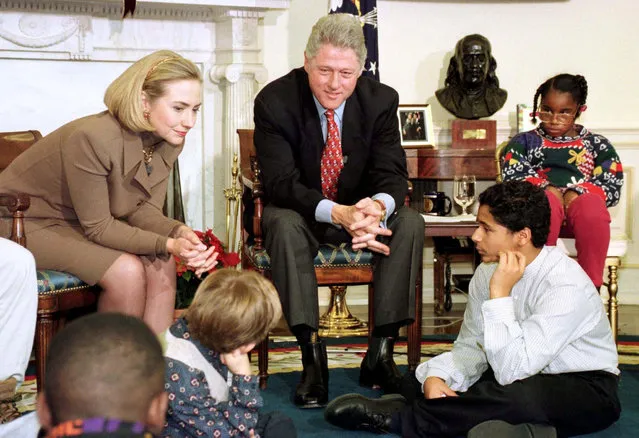 President Clinton and first lady Hillary Clinton talk with children awaiting adoption after the president delivered his weekly radio address from the Oval Office, December 14, 1996. (Photo by Reuters)