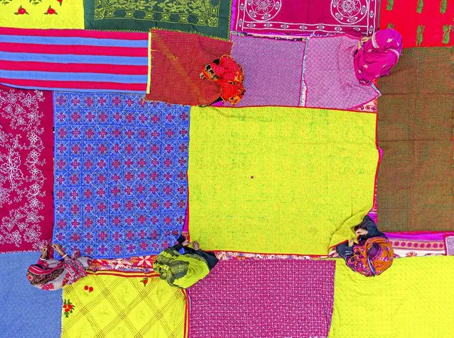 Women and girls embroider quilts made from saris in a centuries-old tradition called nakshi kantha in Alampur, Bangladesh in the last decade of May 2023. (Photo by Bipul Ahmed/Solent News)