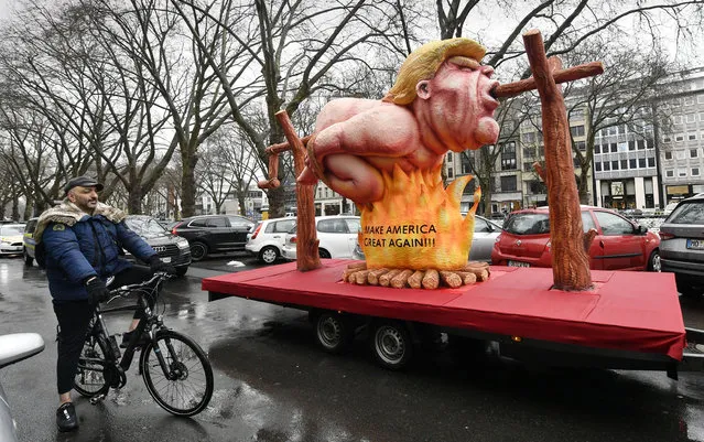 A political carnival float depicting former US president Donald Trump is pulled through the streets in Duesseldorf, Germany, Monday, February 15, 2021. (Photo by Martin Meissner/AP Photo)