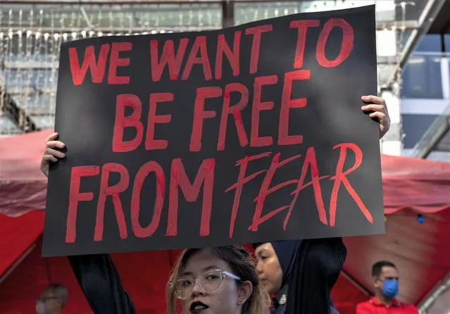 A person holds a placard during Women's March 2023 in conjunction with International Women's Day in Kuala Lumpur on March 12, 2023. (Photo by Asyraf Rasid/ZUMA Press Wire//Rex Features/Shutterstock)