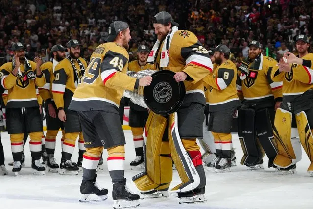 Vegas Golden Knights forward Ivan Barbashev hands the Stanley Cup to goaltender Adin Hill after defeating the Florida Panthers in game five of the 2023 Stanley Cup Finals in Las Vegas, Nevada on June 13, 2023. (Photo by Stephen R. Sylvanie/USA TODAY Sports)