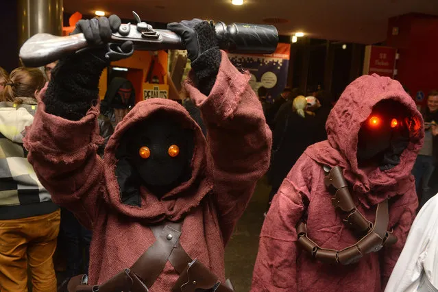 Members of a Star Wars fan club wear costumes of movie characters as they join a midnight premiere of the new Star Wars movie “Star Wars: The Force Awakens” at a cinema in Stuttgart, Germany, late 16 December 2015 night. Numerous fans of the science fiction movie series were gathering to attend one of the midnight premiere screenings all over Germany of the latest movie of the epic series – “Star Wars: The Force Awakens”. (Photo by Nikolai Huland/EPA)