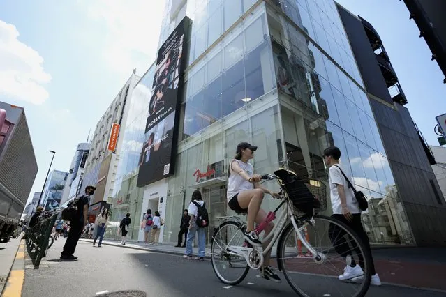 People walk by Fender's Tokyo store Thursday, June 29, 2023. Fender, the guitar of choice for some of the world’s biggest stars from Jimi Hendrix to Eric Clapton, is opening what it calls its “first flagship store” in its 77-year history. (Photo by Eugene Hoshiko/AP Photo)