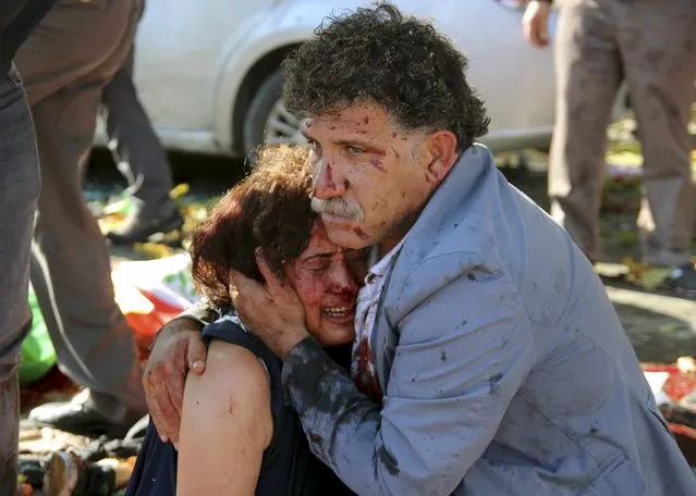 An injured man hugs an injured woman after an explosion during a peace march in Ankara, Turkey, October 10, 2015. (Photo by Tumay Berkin/Reuters)