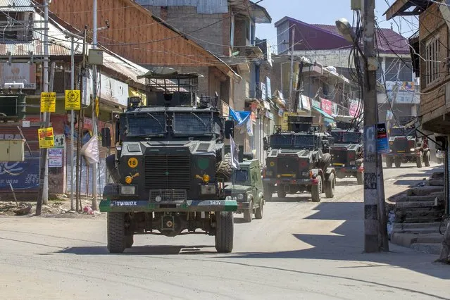 Indian army vehicles leave after the site of a gunbattle in Shopian, south of Srinagar, Indian controlled Kashmir, Friday, April 9, 2021. Seven suspected militants were killed and four soldiers wounded in two separate gunfights in Indian-controlled Kashmir, officials said Friday, triggering anti-India protests and clashes in the disputed region. (Photo by Dar Yasin/AP Photo)