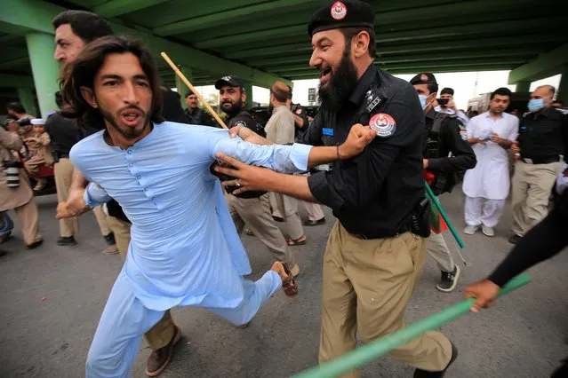 Police detain a supporter of former prime minister and head of opposition party Pakistan Tehreek-e-Insaf (PTI), after he was arrested following court orders that sentenced him to three years in prison in the Toshakhana case, in Peshawar, Pakistan, 05 August 2023. Imran Khan has been arrested by Punjab police after an Islamabad trial court found him guilty of 'corrupt practices' in the Toshakhana case, PTI's general secretary Omar Ayub confirmed. The court sentenced him to three years in prison and imposed a fine of Rs100,000 for concealing details of Toshakhana gifts. Imran's lawyers were not present during the trial. The court order stated that Imran had committed offenses of corrupt practices by making false statements and declarations about assets acquired from Toshakhana. Imran's arrest comes three months after his previous arrest in the Al-Qadir Trust case, which led to widespread violence and a crackdown against his party. (Photo by Arshad Arbab/EPA/EFE)