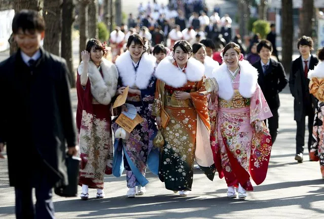 Japanese women wearing kimonos walk as they attend a Coming of Age Day celebration ceremony at an amusement park in Tokyo January 11, 2016. (Photo by Yuya Shino/Reuters)