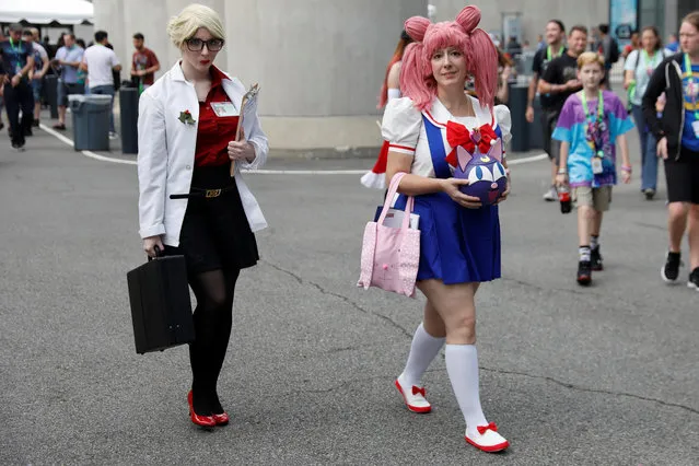 People dressed up in costumes attend the 2018 New York Comic Con in Manhattan, New York on October 4, 2018. (Photo by Shannon Stapleton/Reuters)