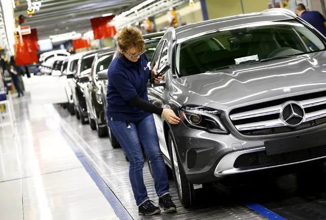 Employees of German car manufacturer Mercedes Benz make final adjustments at the end of the Mercedes A class (A-Klasse) production line at the factory in Rastatt, Germany, January 22, 2016. (Photo by Kai Pfaffenbach/Reuters)