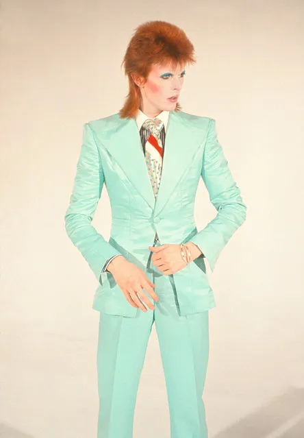 David Bowie, Life on Mars, 1973 by Mick Rock. “David Bowie asked me to shoot a video for Life on Mars for its release as a single. I photographed him in the Freddie Burretti suit he wore for it with makeup by Pierre La Roche (who had styled him for the cover of Aladdin Sane). He never wore that suit again, never had that makeup on again. He never looked more amazing – like a space doll. A couple of months later he famously retired the androgynous Ziggy Stardust character, after which he started wearing a lot of tailored suits. This photograph catches him morphing from one look to another”. (Photo by Mick Rock/Rock Sale2018)